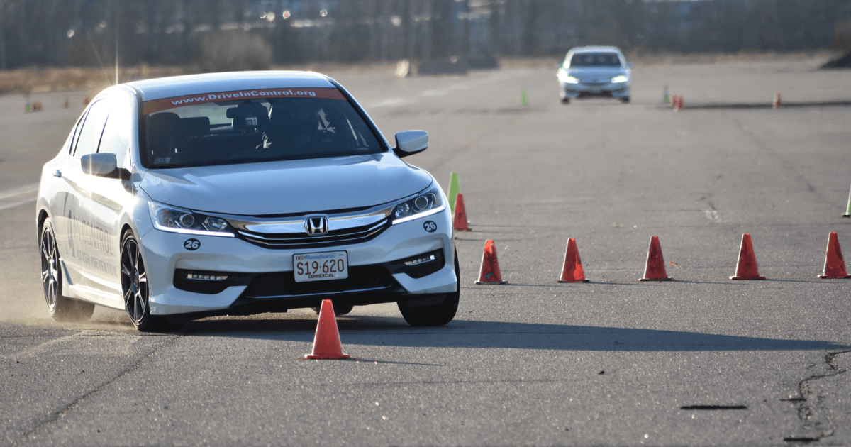 A car evasively turning around cones will under hard brakinge