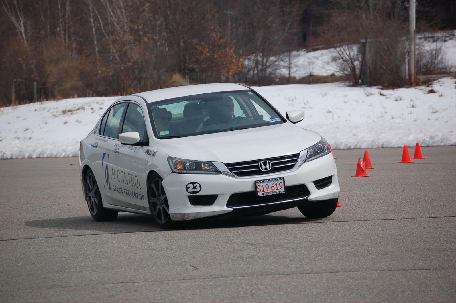 A car making a hard turn in a winter driving training course